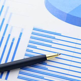 black pen sitting on paper with blue graph