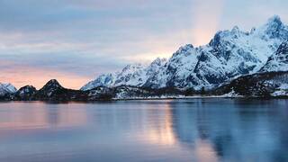 landscape image of snowy mountains on a lake